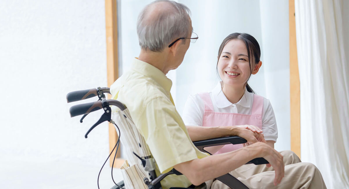 An in-home caregiver supporting an elderly couple live comfortably