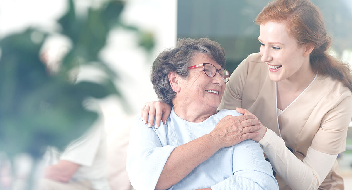 A carer assisting senior care with long term needs