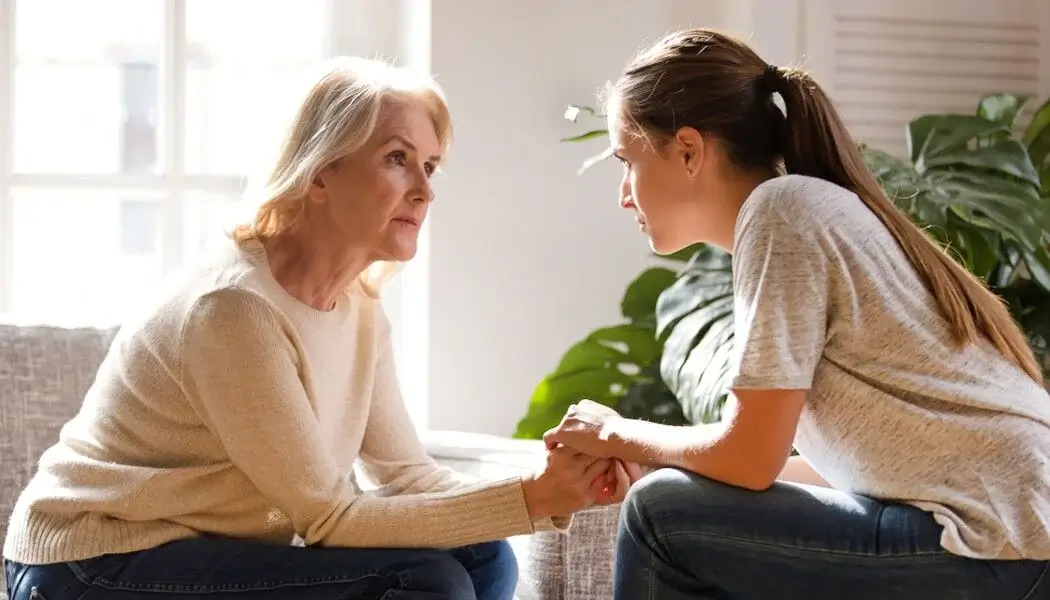A carer assisting an elderly person suffering from a mental health problem