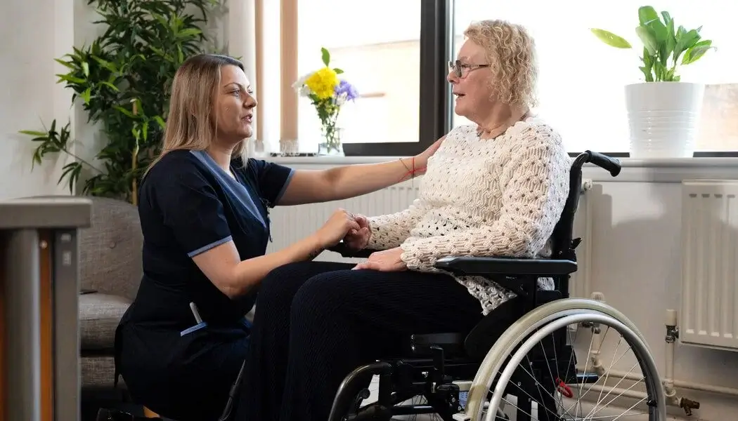 Carer provides in-home care to an elderly woman who is physically disabled